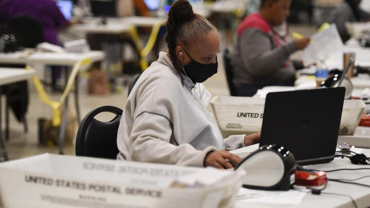 Cobb County election officials prepare mailed ballots for the US Senate election run-offs in Marietta, Georgia, on November 24, 2020.